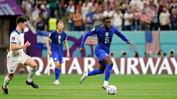 USMNT forward Timothy Weah dribbles against England